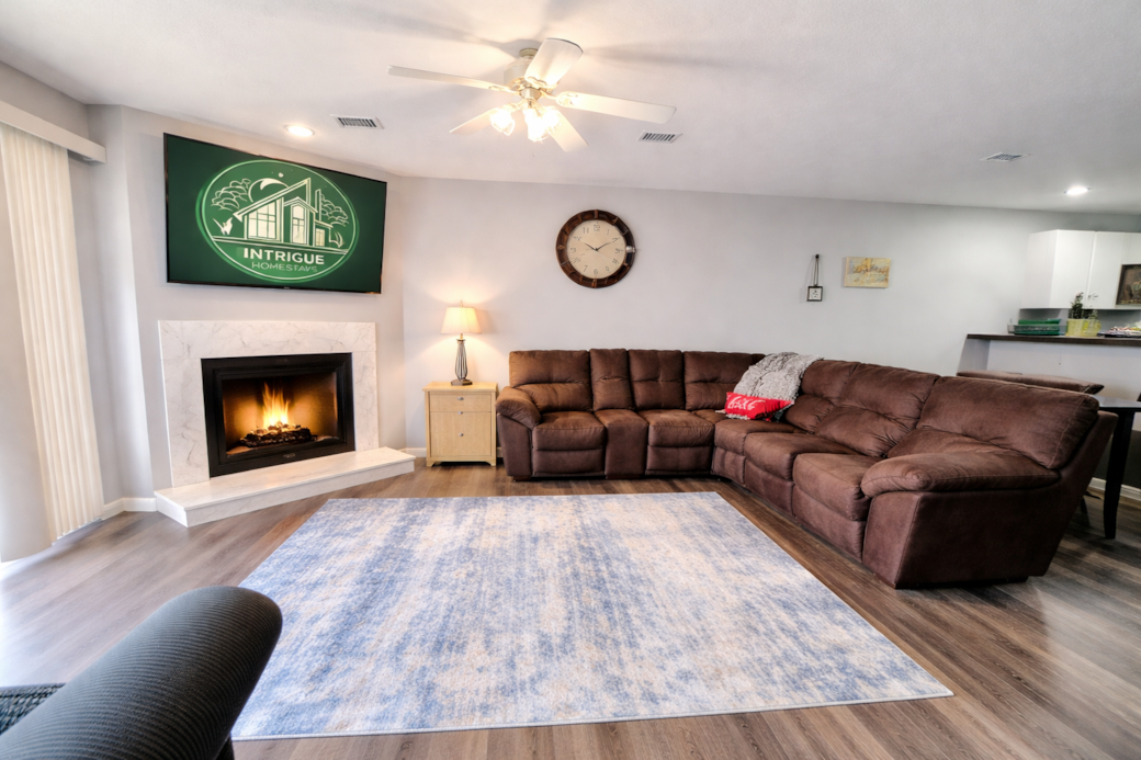 Spacious living room with fireplace and large sectional—perfect for relaxing after the lake. Spacious living room with fireplace and large sectional—perfect for relaxing after the lake.