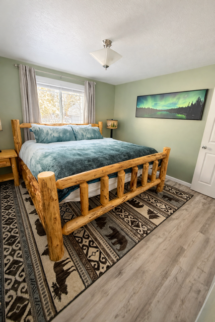 Cozy log bed blending rustic charm with modern comfort.