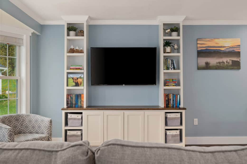 This beautiful built in houses a 55" smart TV as well as various book and games.