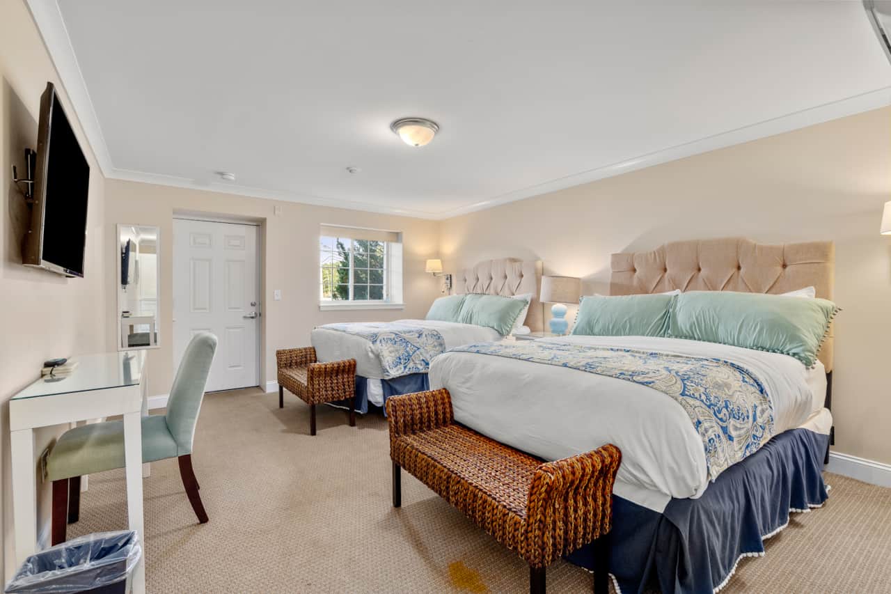 Large and spacious room with two queen beds, dedicated workspace, clean linens, and private entrance