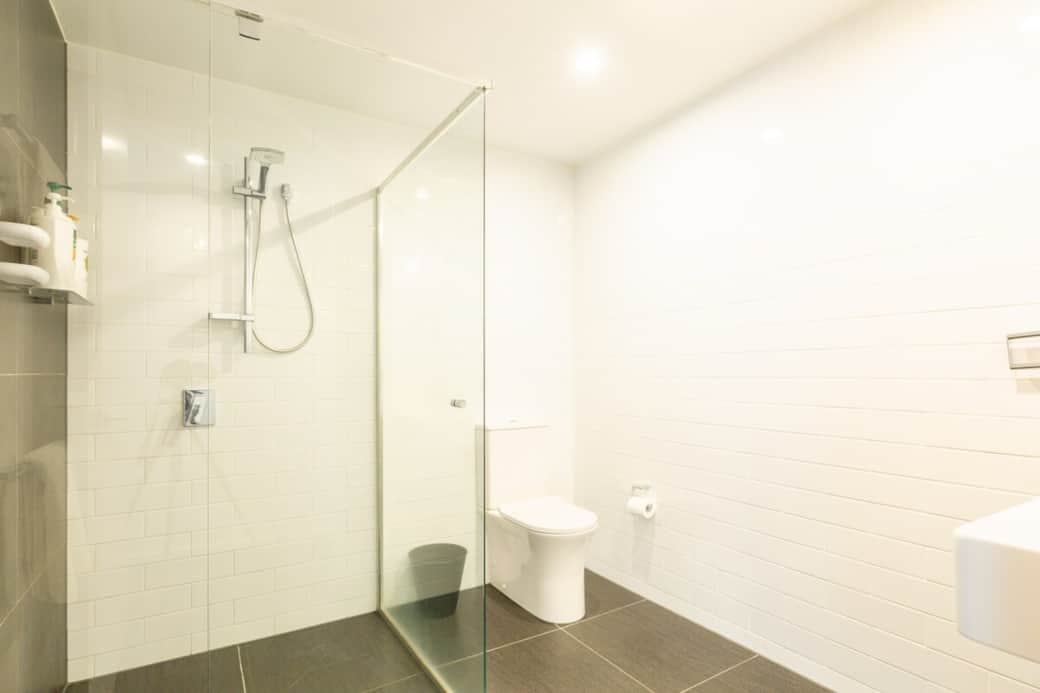 Step into a world of modern elegance with our sleek bathroom, featuring a walk-in shower. The clean lines and neutral palette provide a tranquil space for your daily rituals, ensuring comfort and style.