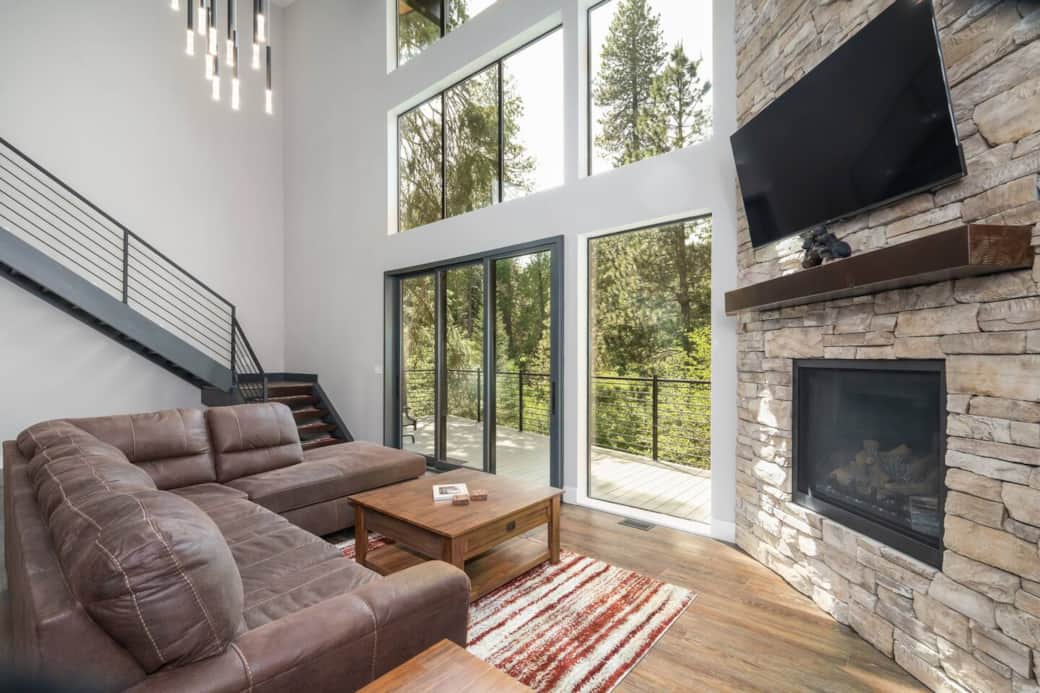 Floor to ceiling windows make a beautiful natural canvas for the forest trees.  Enjoy the gas fireplace during cold winter evenings.