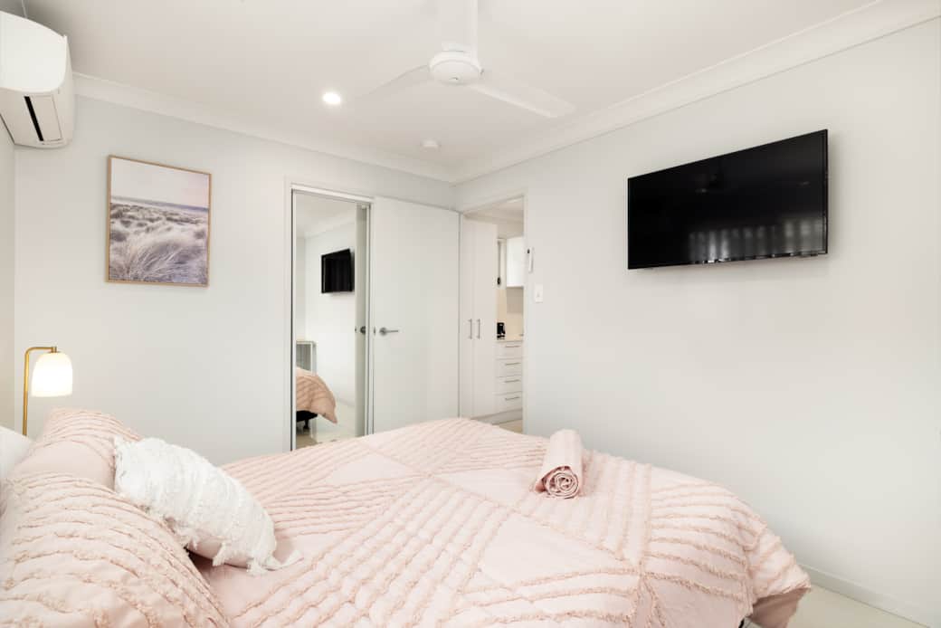 Bedroom: Comfortable room featuring wall-mounted TV