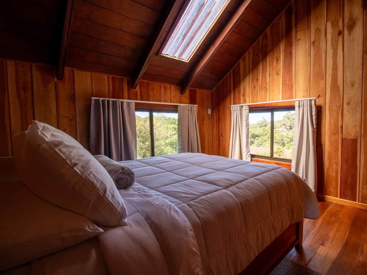 Cozy bedroom with natural light and a comfortable bed for a restful night's sleep.