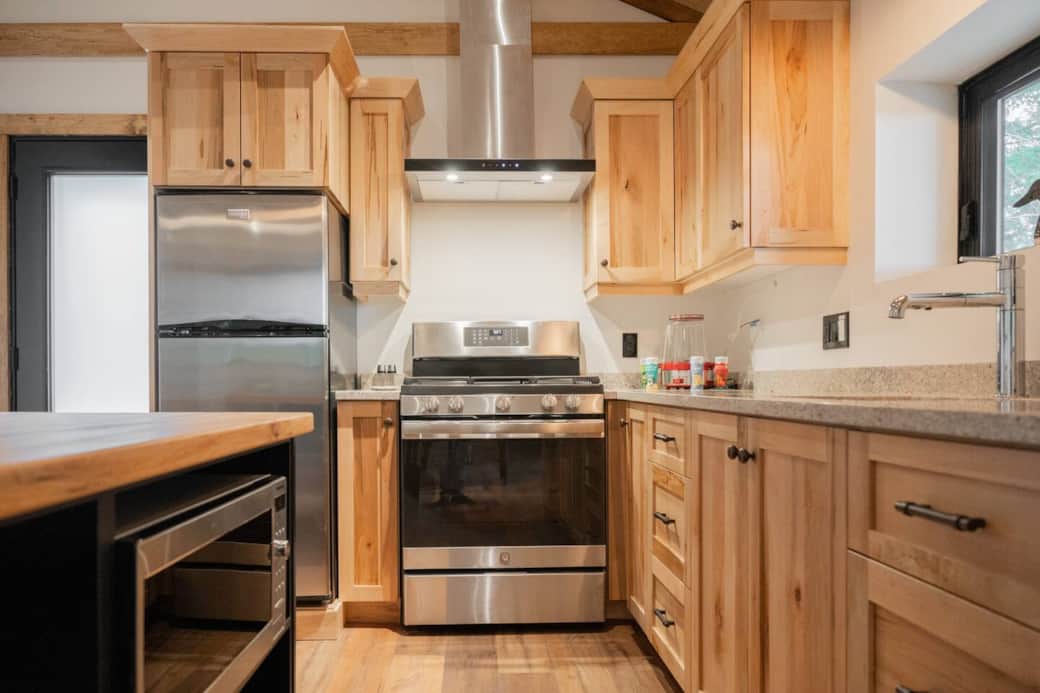 Custom maple cabinets and quartz countertop  kitchen at your service! Brand-new appliances featuring a gas stove,  different spices, popcorn maker, condiments and seasonings. Great space to cook your favorite meals. 