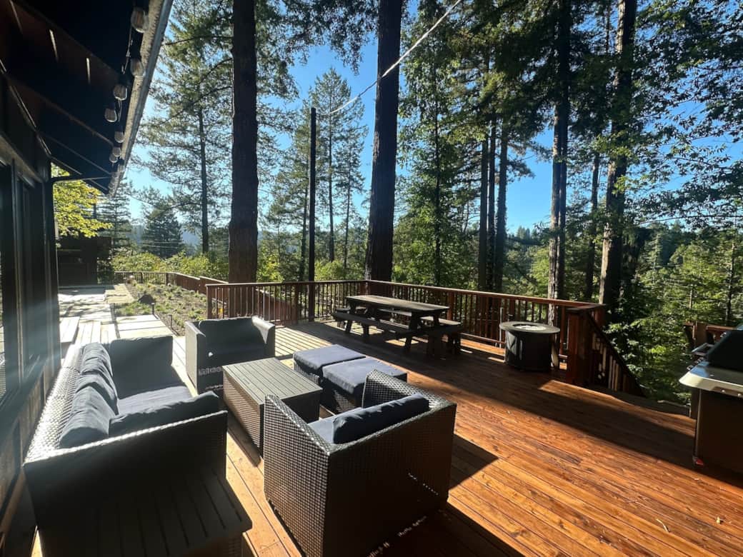 The home is situated on a large lot surrounded by redwood and Douglas fir trees with open valley views. 