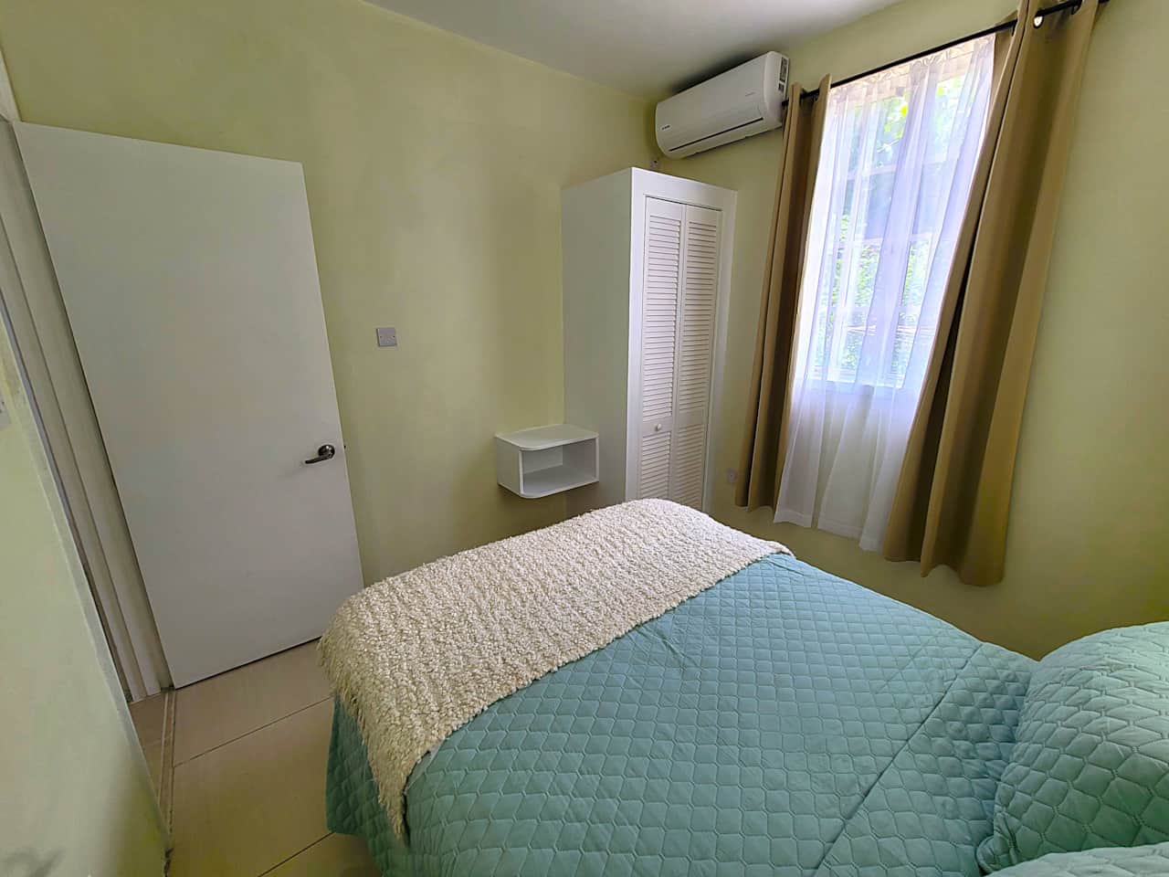 5 Bright double bedroom with high-quality linens and large windows at Garden View Apartments.