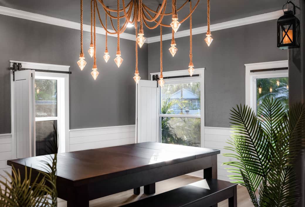 formal dining room featuring a convertible pool table beneath a striking rope chandelier. formal dining room featuring a convertible pool table beneath a striking rope chandelier.