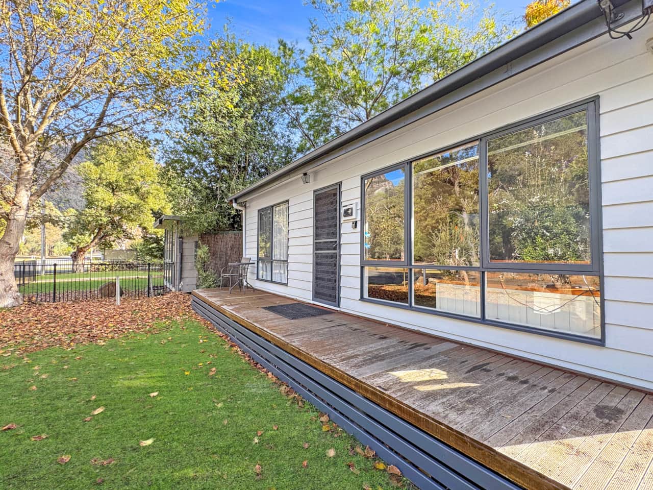Luminous charm: Sun-drenched cottage radiates warmth and tranquility. 