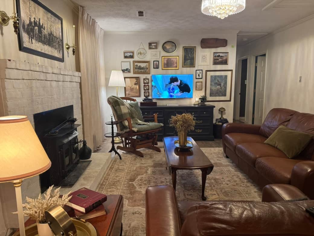 Cozy living room with wood burning fireplace.