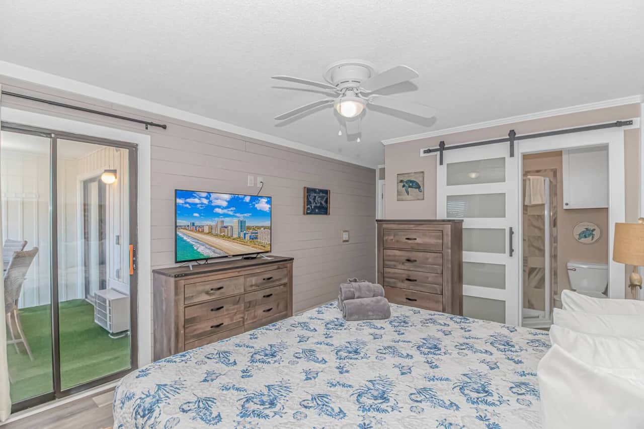 Master bedroom with private en-suite bathroom with updated barn door and a second private  access to the balcony!