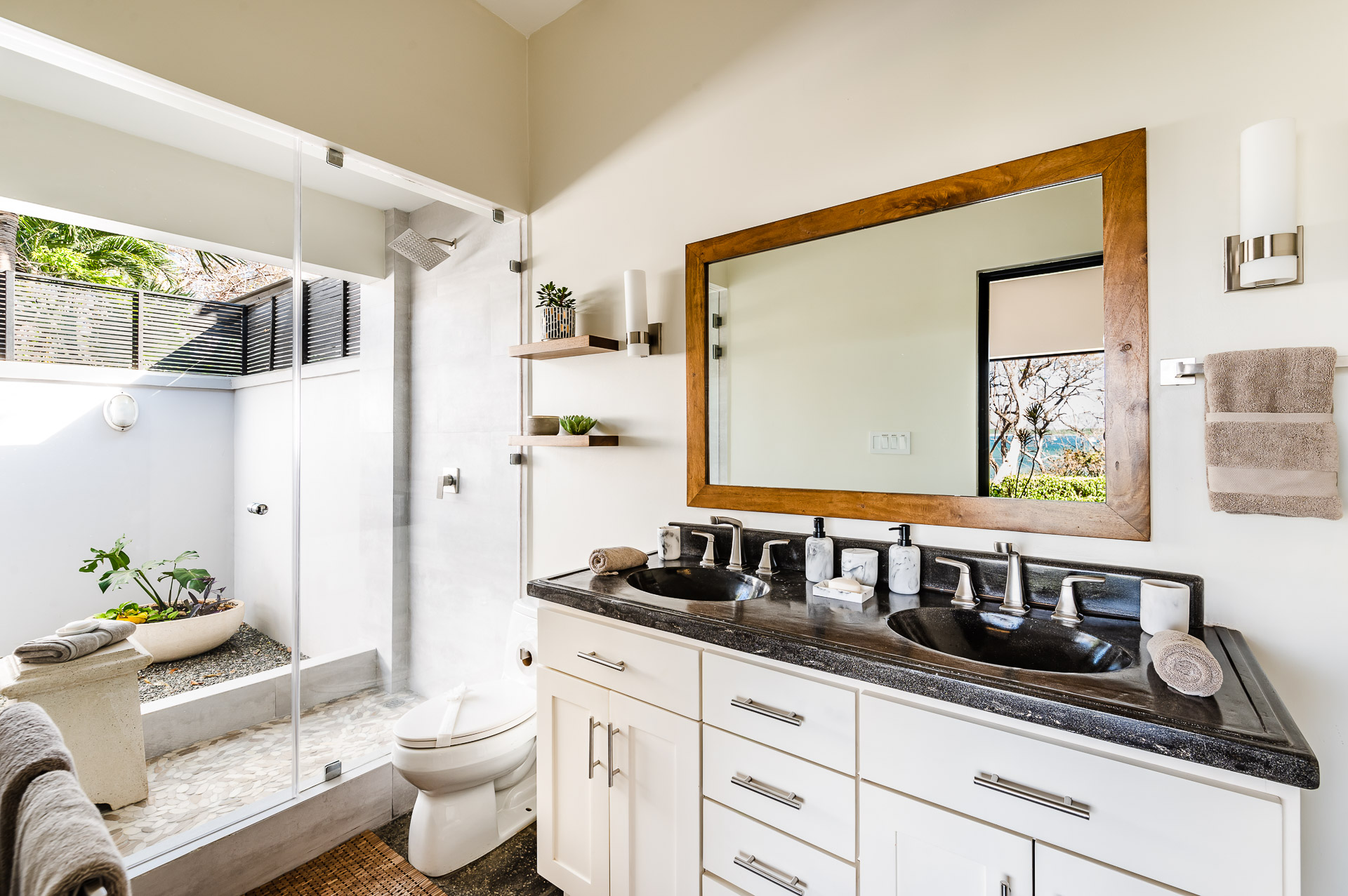 Indoor/outdoor shower and spacious Mr. & Mrs. double sink vanity.
