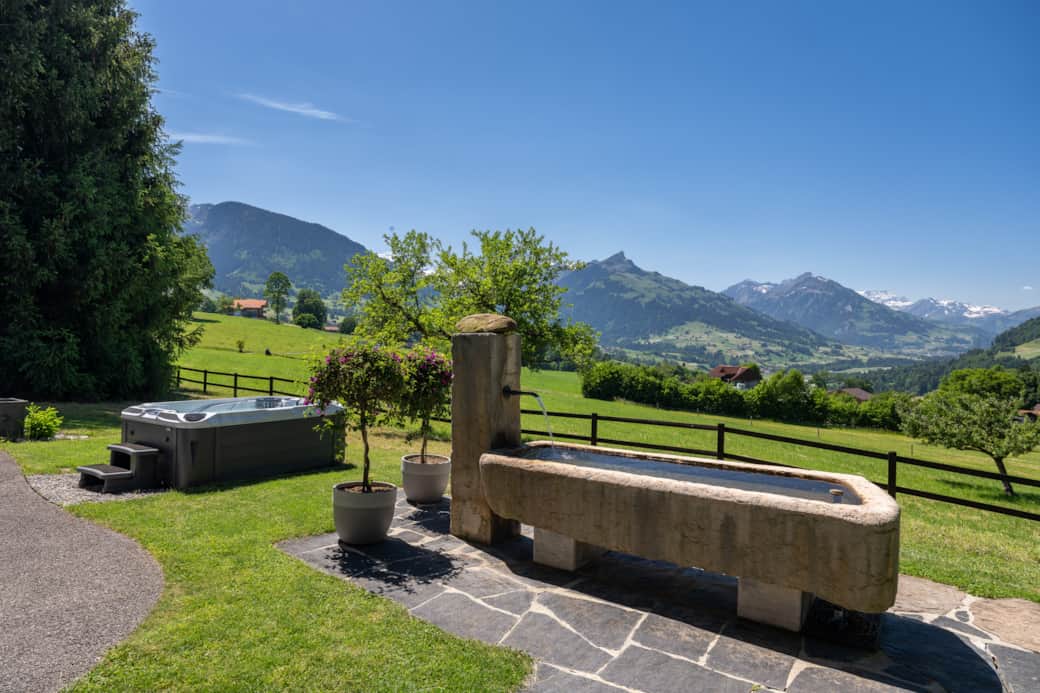 Our front yard features a large stone fountain, ideal for refreshing dips on warm days.