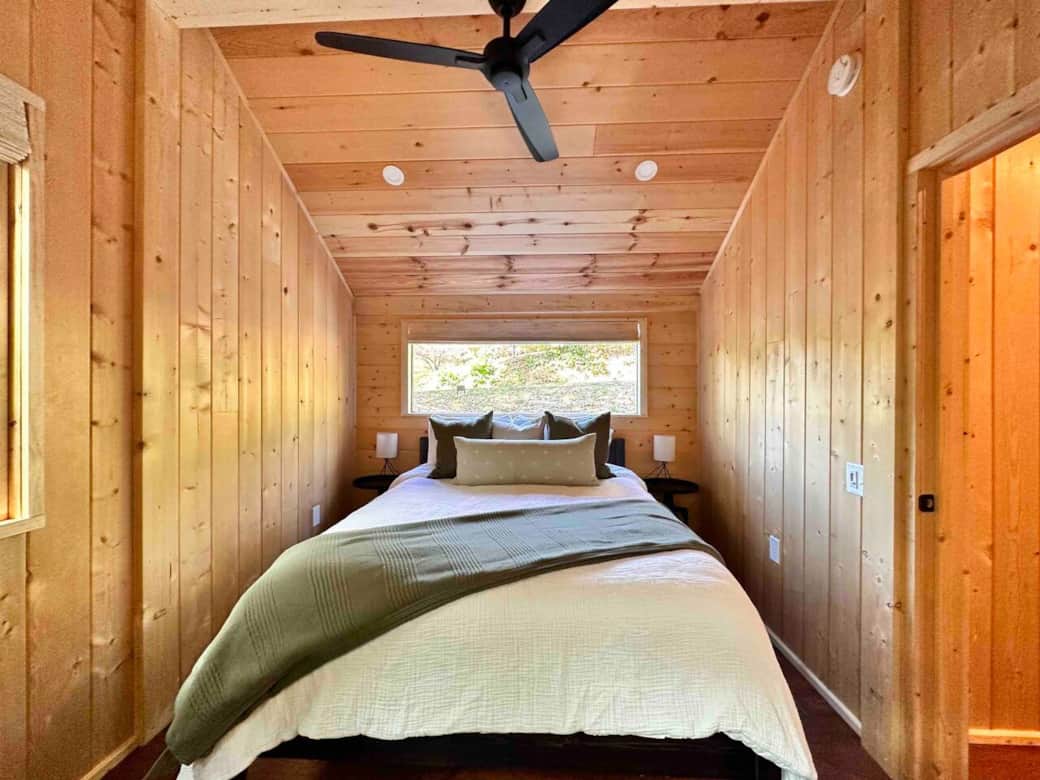 Wake up to wooded views from the minimalist Scandinavian bedroom with premium bedding.