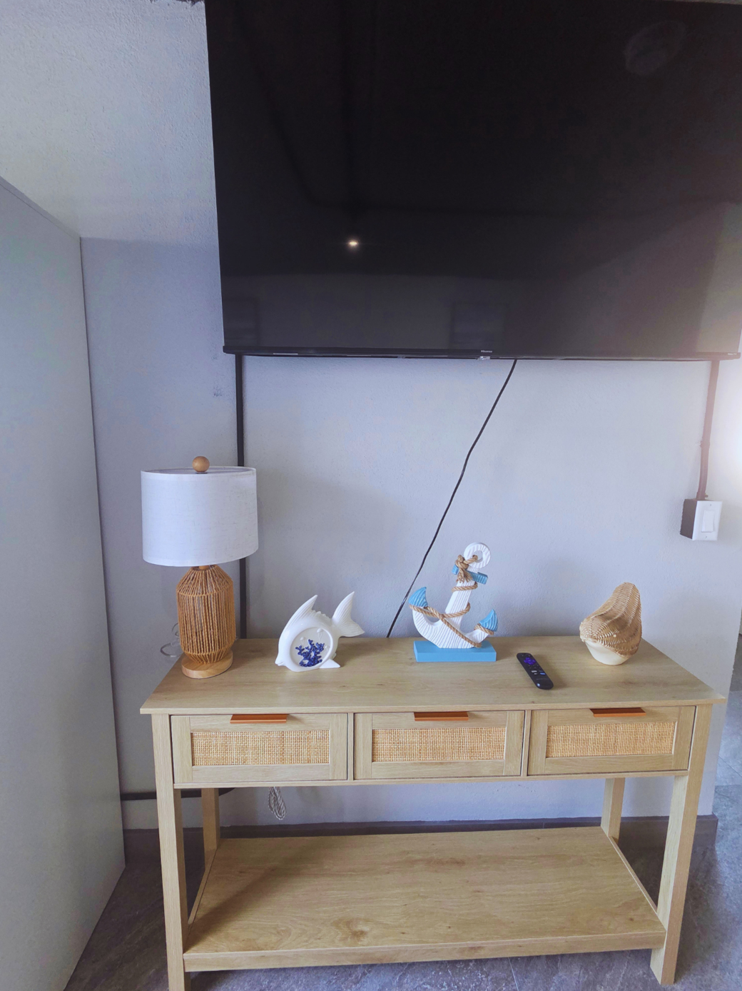 Beach-inspired coffee table with anchors, fish decor, and elegant lighting. Treasure Island, FL