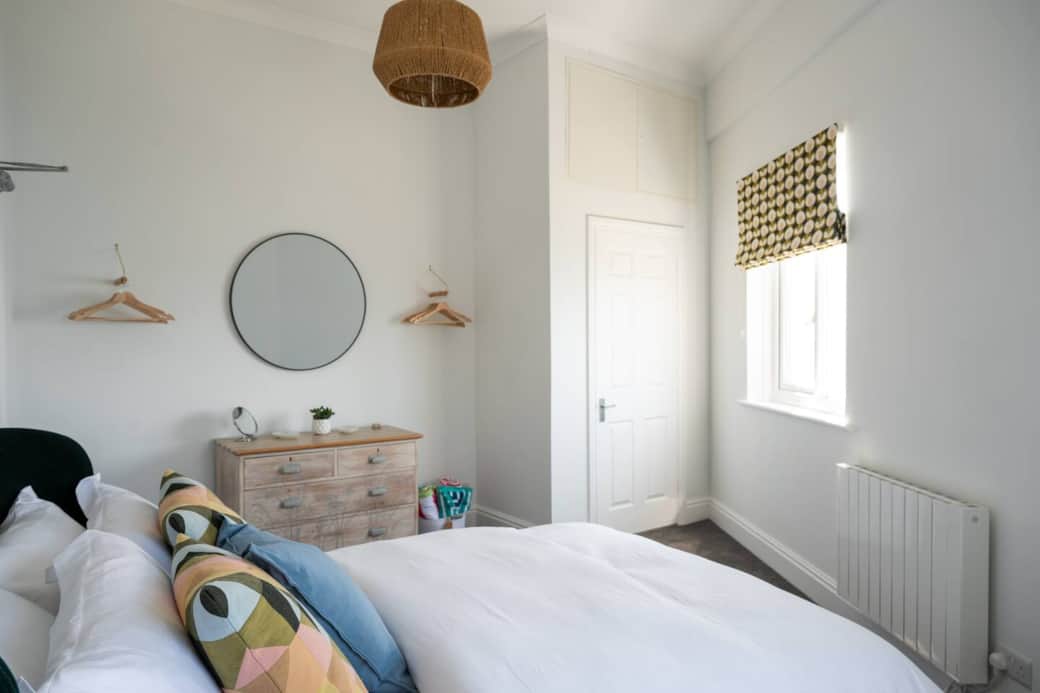 The double bedroom  with beautiful white linen ,ample storage and hangers 