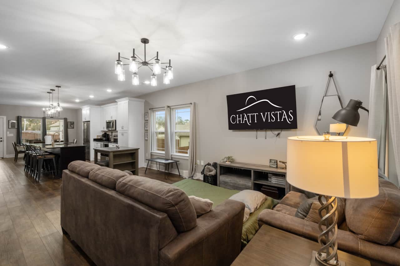 Open Concept Living Room with 65" 4K Flat Screen & Queen Fold Out Mattress