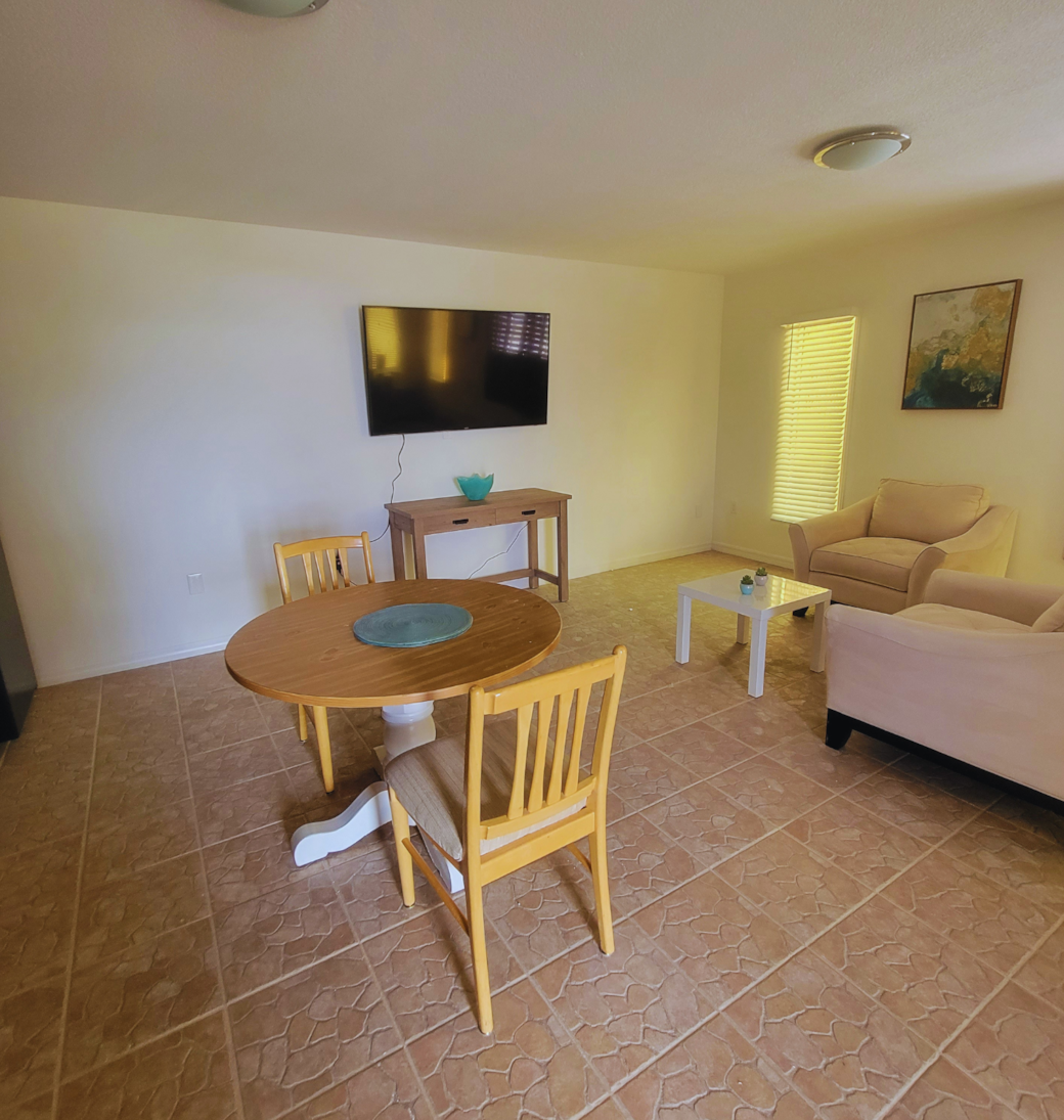Charming wooden dining table for two, conveniently located near the living area and TV. Lakeland, FL Charming wooden dining table for two, conveniently located near the living area and TV. Lakeland, FL