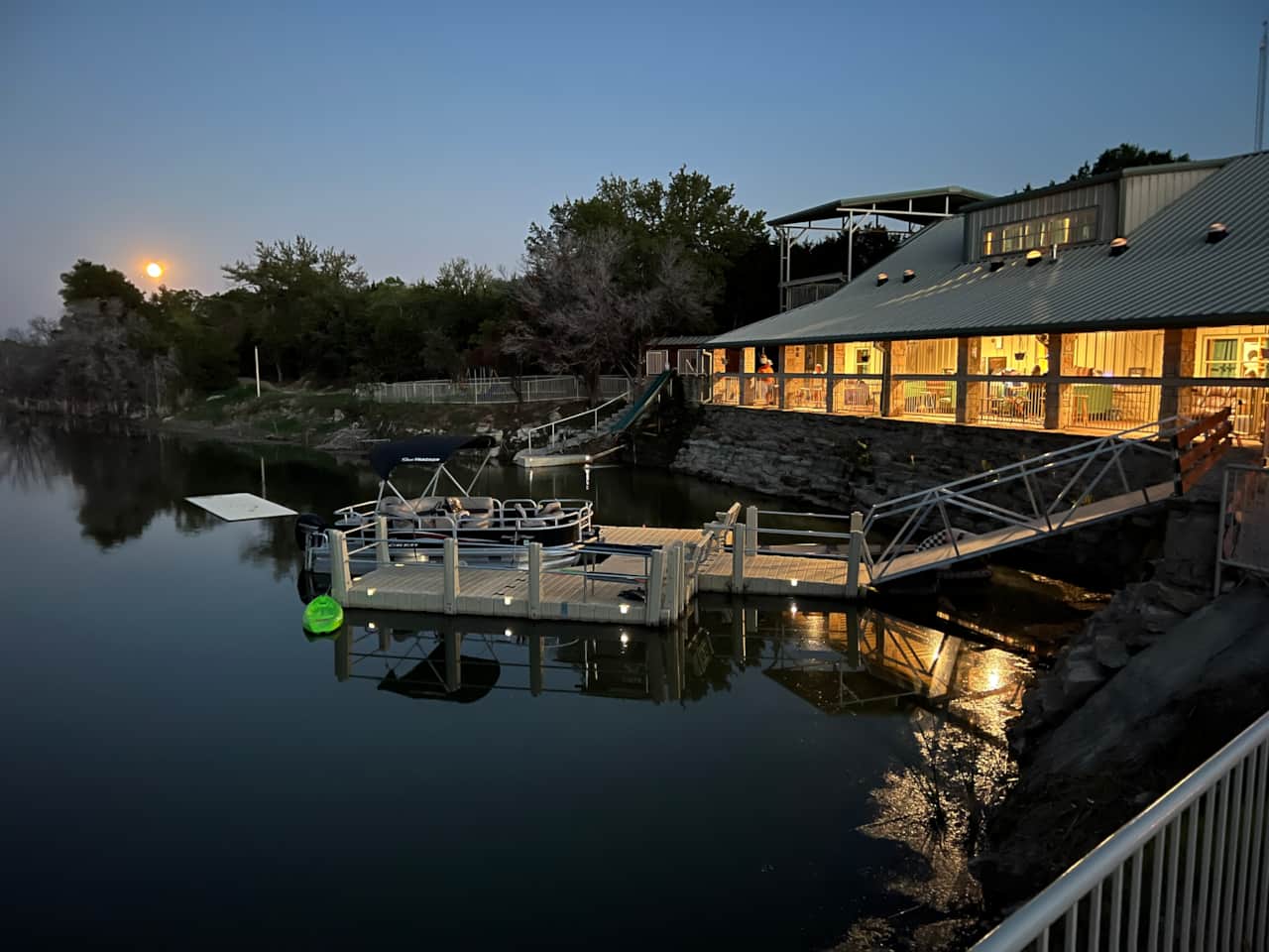 Moon rising over the 35-bed Lake Godstone lodge at night during a Texas family reunion in Graford TX