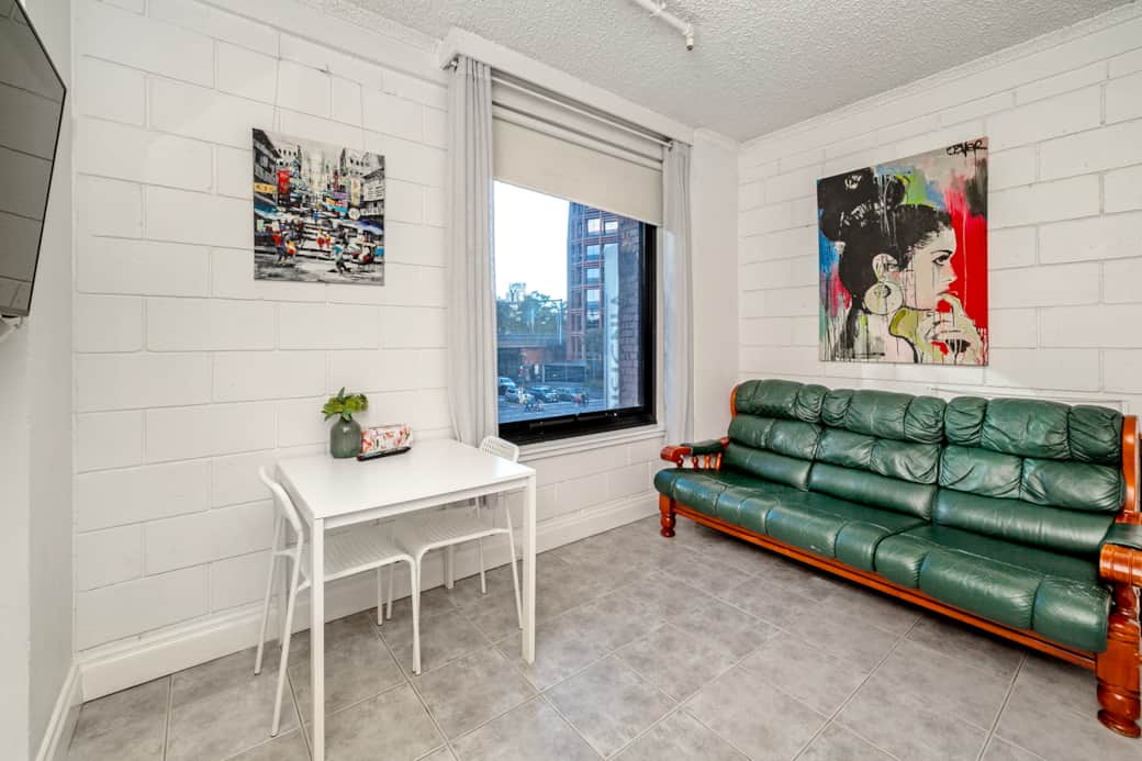 Comfortable living area with couch and large screen TV Flinders Street studio Melbourne ShelleyStayz