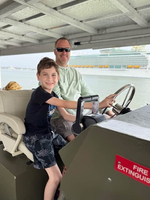 Boy helping drive a ferry boat in Galveston