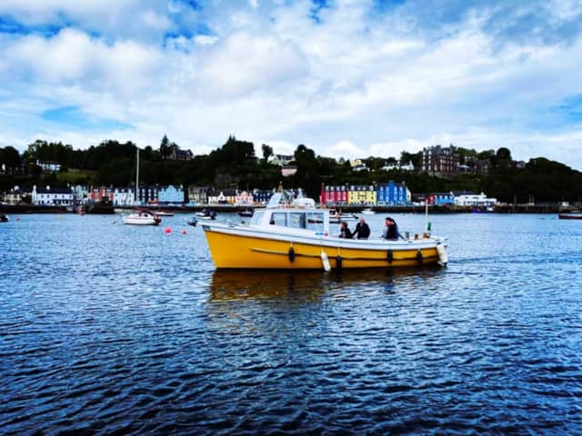 Yellow Tobermory Bay Tours boat in front of the waterfront
