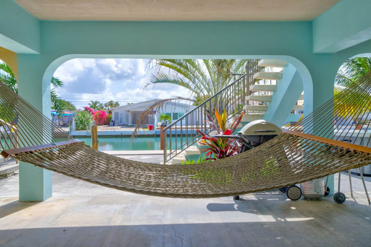 Swing in the hammock under the house with the canal in front of you and the grills close by. Downsta