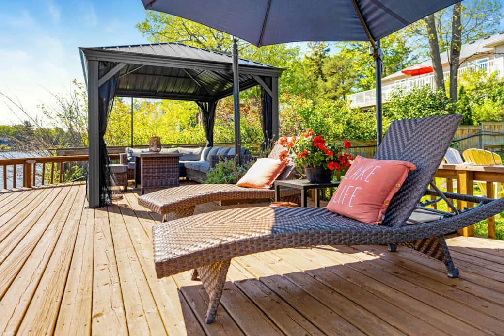 Relax on a plush lounge chair, basking in the warm embrace of the sun's rays as they kiss your skin. With a gentle breeze from the nearby river, you'll find serenity in the rhythmic lull of water flowing.