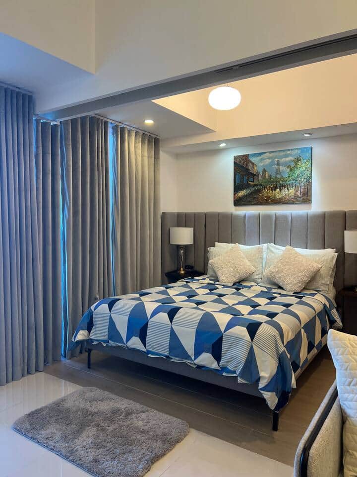 
The bedroom is furnished with a queen-size bed and a comfortable mattress, covered with soft bed linens, along with black-out curtains.