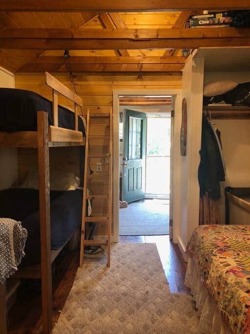 The bedroom has bunk beds on the left and a double bed on the right The bedroom has bunk beds on the left and a double bed on the right
