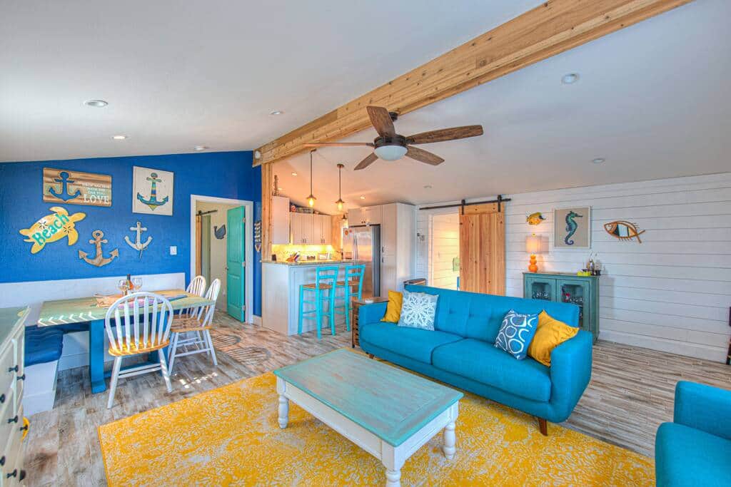Two full couches in the den with an extendable coffee table that turns into a work desk. 