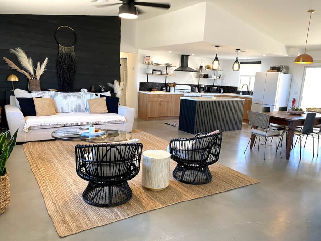 Spacious open layout with living room, dining area, and fully equipped kitchen.