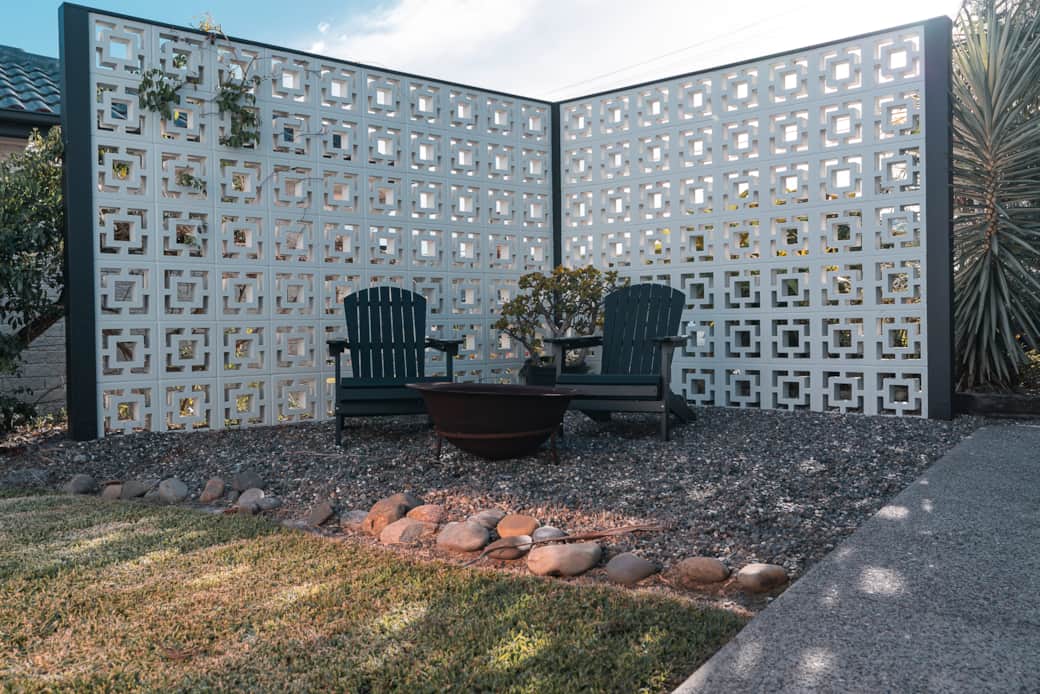 Back garden with Cape Cod chairs and wood firepit
