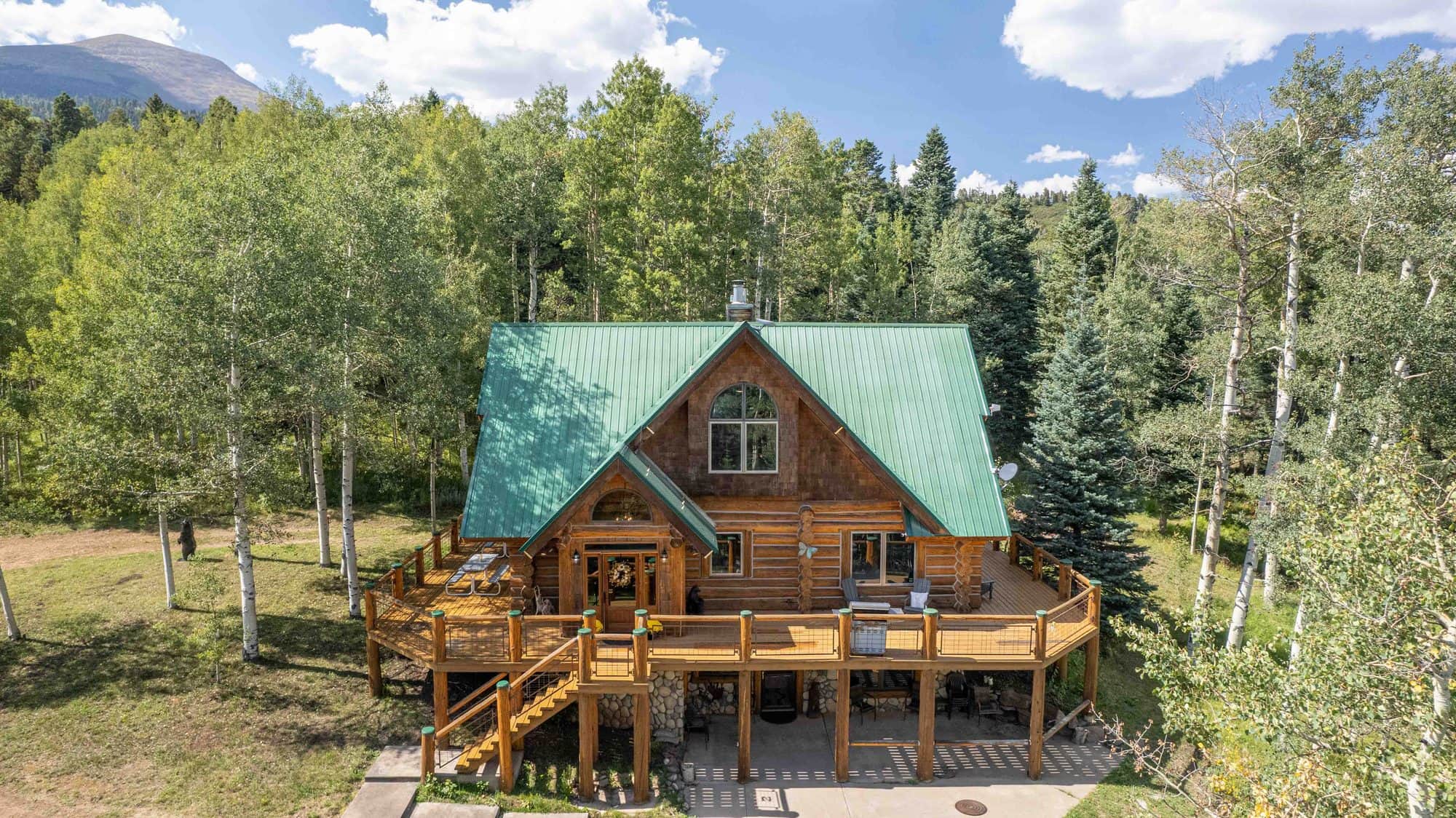 Aerial view of A Creek Runs Through It log home among aspens in Westcliffe, Colorado