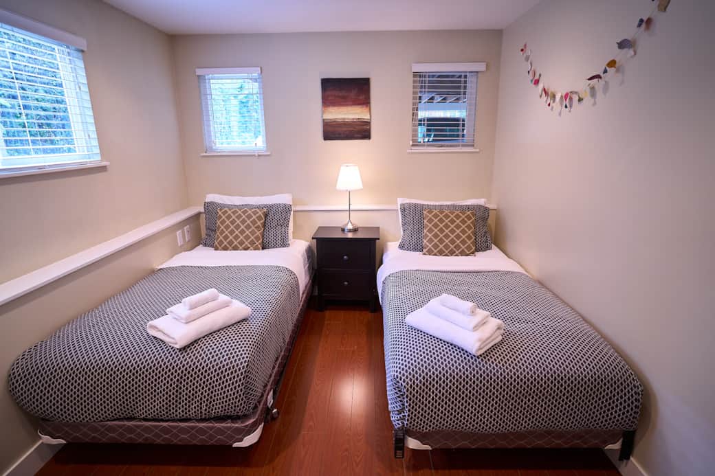 Bright second bedroom with dual twin beds comfortably accommodates children or adults Bright second bedroom with dual twin beds comfortably accommodates children or adults