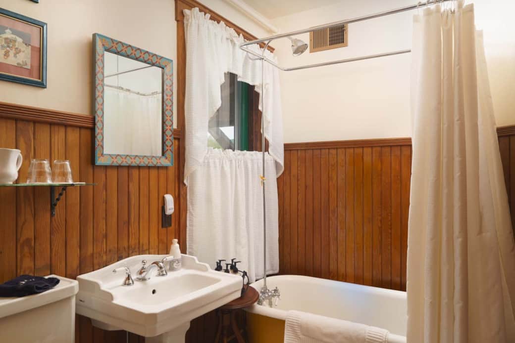 Private bath with shower over claw-foot tub in Meadow Suite. Private bath with shower over claw-foot tub in Meadow Suite.