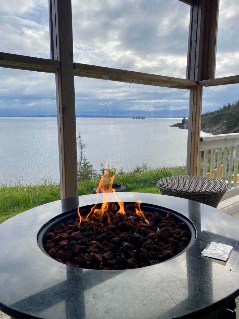 An end cottage with sunroom and propane fire table