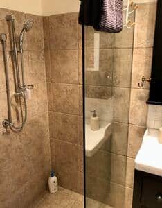 Full sized shower and room for bathroom storage.