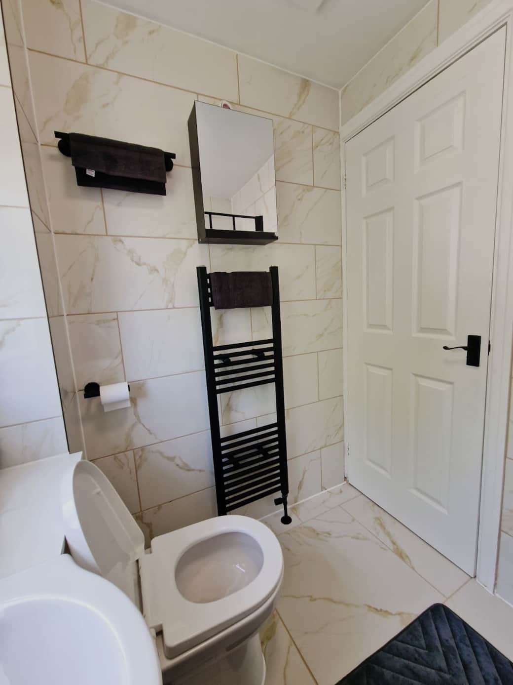 Modern bathroom with heated towel rail.