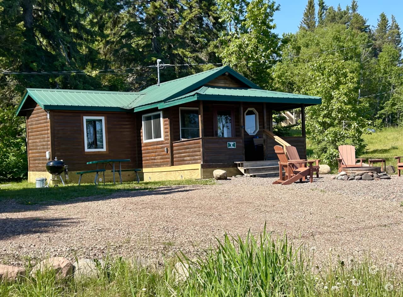 Eve's Place Cabin 2 with darling front porch and firepit. Charcoal grill and picnic table front left