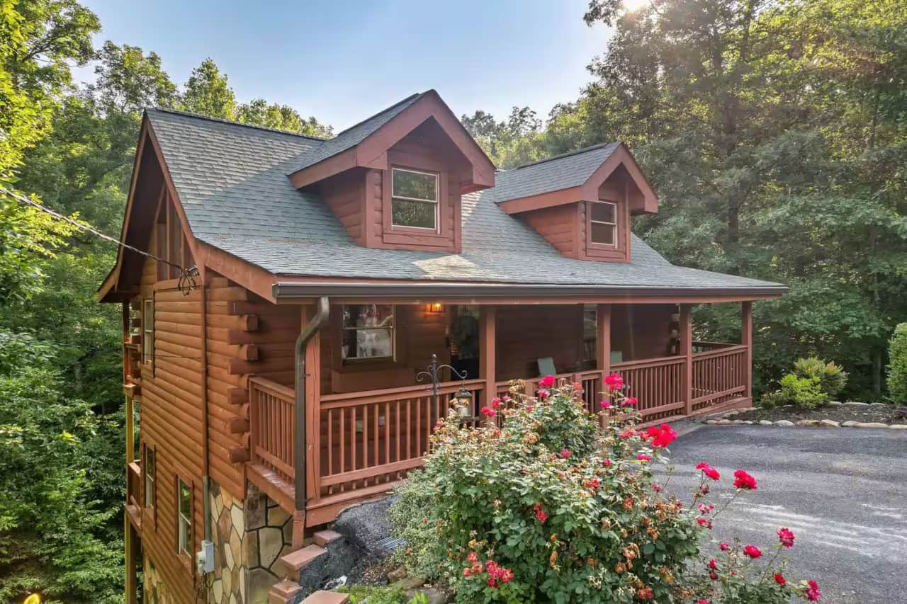 Charming log cabin tucked in the woods with a covered porch, easy parking, and a peaceful setting