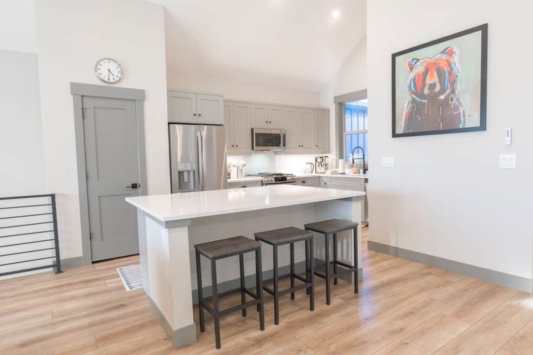 Fully equipped kitchen with modern appliances and a large, elegant island for gathering.