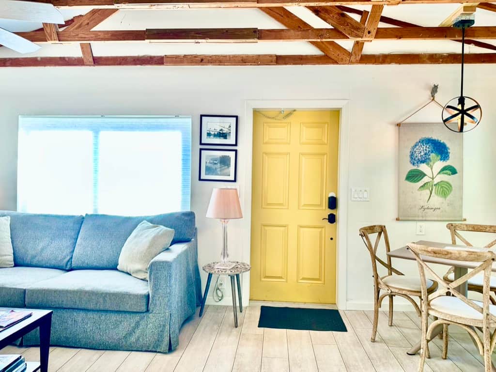 Bright renovated living room in Unit 2 at Casa Citron with impact windows, central AC, modern lighting, and a sofa bed for flexible guest comfort.