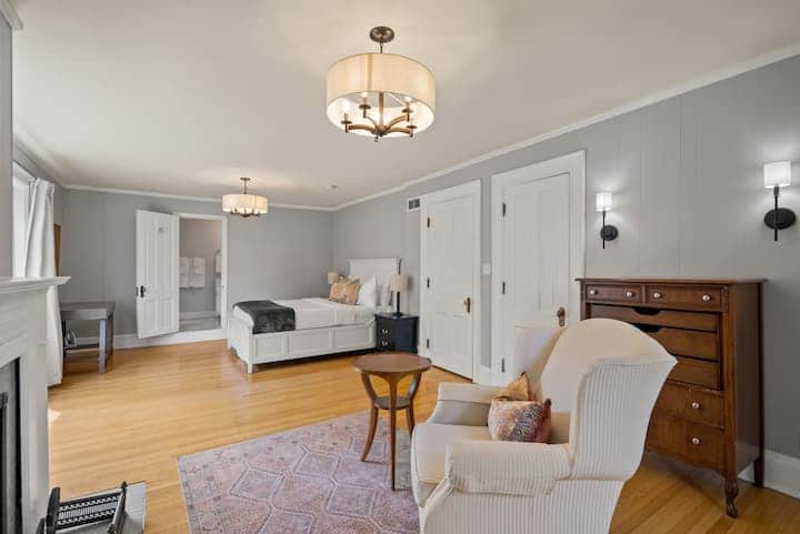 Bright and airy suite with elegant finishes, cozy seating, and a charming fireplace