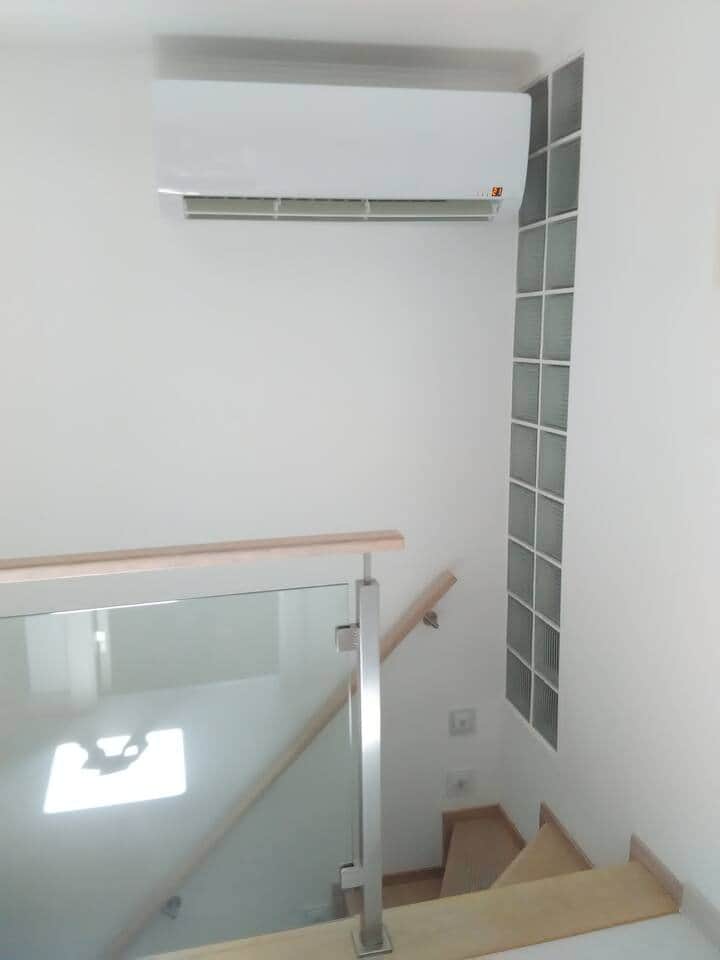 Air conditioned located on the top of stairs serving the second bedroom and the living room area