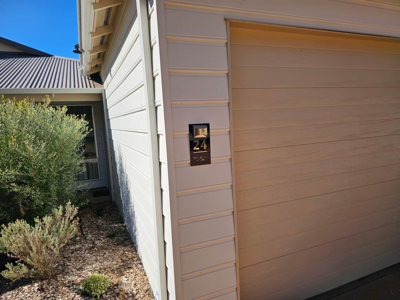 House sign in front of house