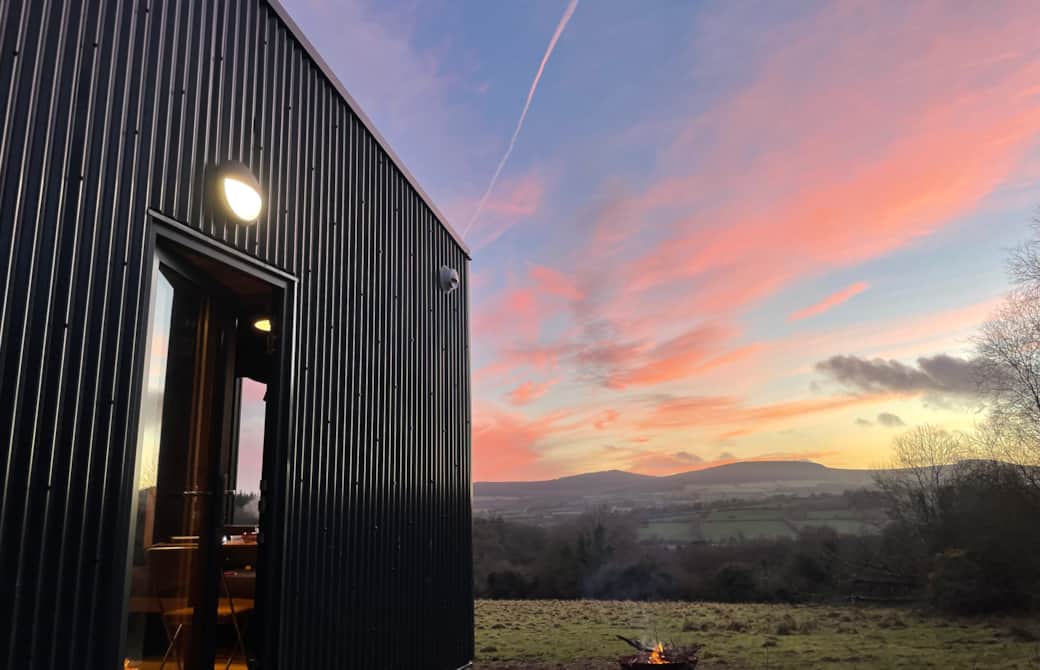 Golden hour illuminating the cabin's sleek exterior