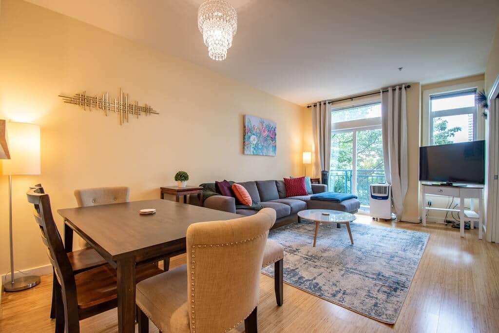 Living Room with Floor to Ceiling Windows & Large Television  