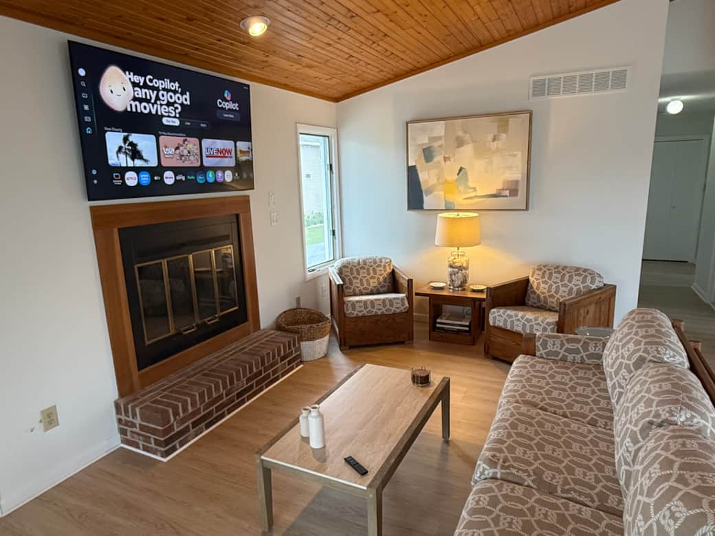 The Great Room combining the kitchen & living room. A new 65" Smart TV. New flooring, paint, decor