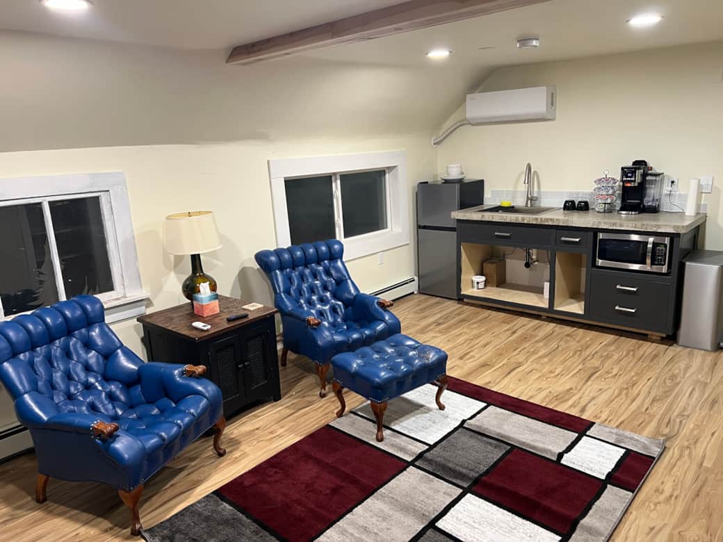 Living area includes a small kitchenette with Refrigerator and microwave, along w/ drip/kcup coffee.